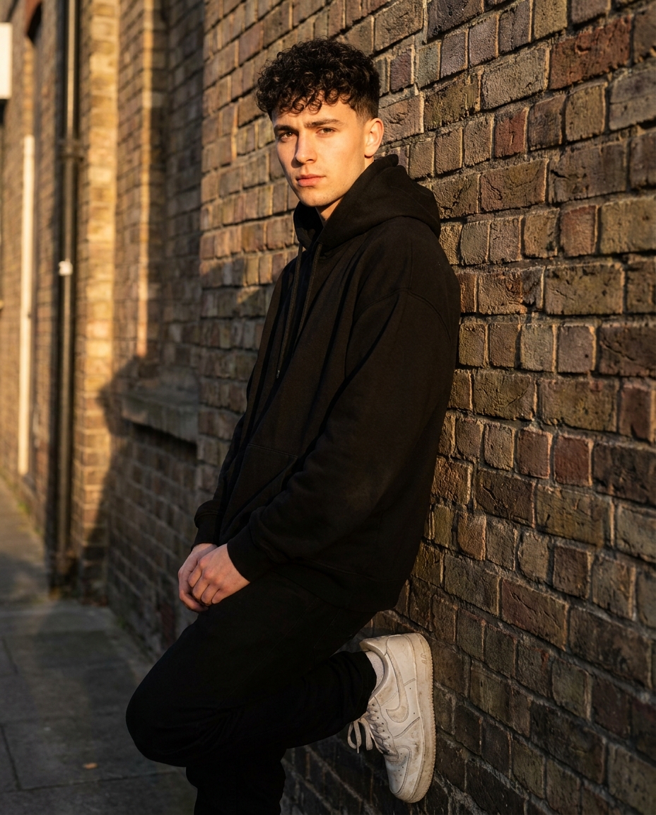 Male AI influencer street style, black hoodie, golden hour